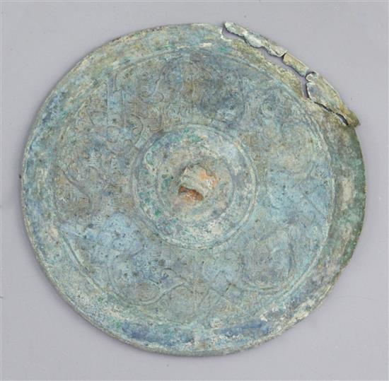 A Chinese bronze circular mirror, Eastern Zhou dynasty, 4th-3rd century B.C. 14cm diameter, damaged